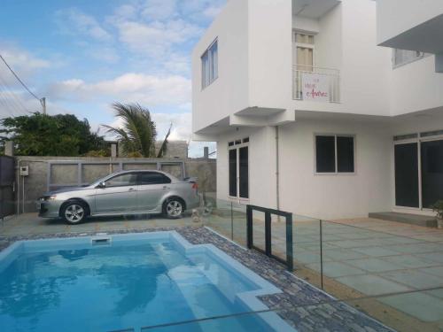 a car parked next to a house with a swimming pool at villas andrez in Savinia