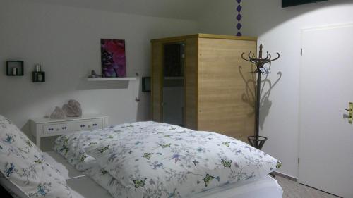 a bedroom with a bed and a wooden cabinet at Unseburger Brauhaus GmbH Ferienwohnung 5 in Unseburg