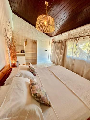 a bedroom with a large bed with pillows on it at Villa Mango in Icaraí