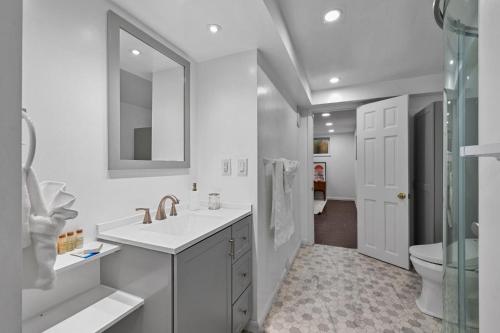 a white bathroom with a sink and a toilet at Lunceford - Northglenn in Northglenn