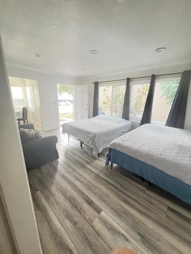 a bedroom with two beds and a couch at Little Bettys Cottage in Torrance