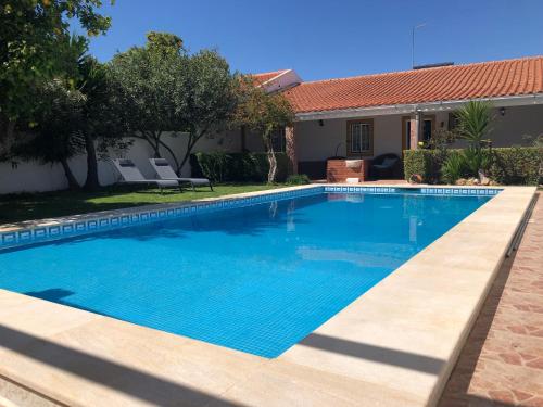 a swimming pool in front of a house at Casa d'Aldeia in Casa Branca