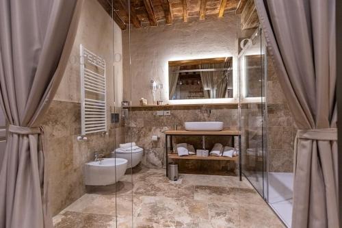 a bathroom with a shower and a sink and a toilet at Truffle House Tuscany Magnatum Pico in Montepulciano
