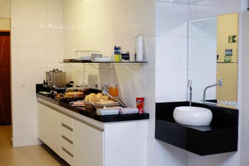 a kitchen with a counter with food on it at Hotel Madrugada in Sao Paulo