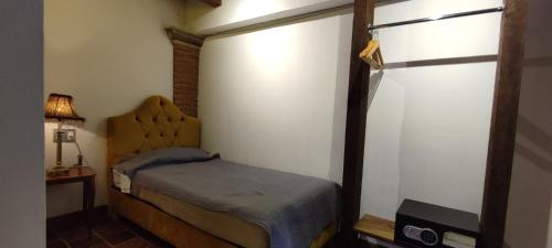a small bedroom with a bed and a window at Hotel Grand Maria in San Cristóbal de Las Casas