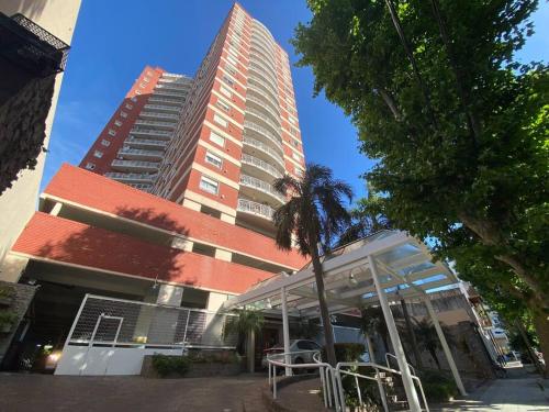 a tall building with a table in front of it at Tigre Center Tower B - Con parking, piscina y seguridad 24hs in Tigre