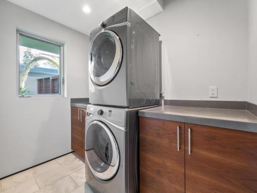 a kitchen with a washer and dryer in it at Luxury Coastal Home - Pool, Spa, AC, & Ocean Views in Solana Beach