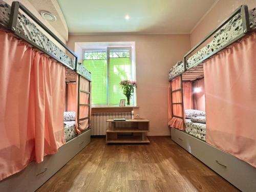 a room with two beds and a window at Kust Hostel in Kyiv
