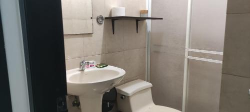 a bathroom with a toilet and a sink at Hotel Mykonos Manta in Manta