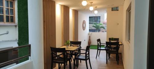 uma sala de jantar com mesas e cadeiras e um relógio em Hotel Mykonos Manta em Manta