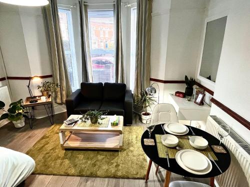 a living room with a couch and a table at Reservoir Retreat in Birmingham