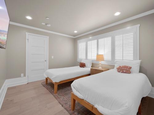 a bedroom with two beds and a window at Kennebeck Oasis - Private Patio, Steps 2 Sand & AC in San Diego