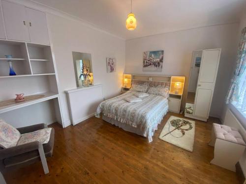 a bedroom with a bed and a chair in it at Sunrise Cottage in Killybegs