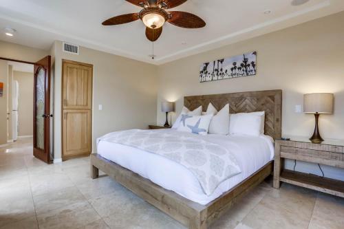 a bedroom with a large bed and a ceiling fan at Stunning Ocean View Home w Rooftop Terrace, Firepit, Fast Wifi, AC & Parking! in San Diego