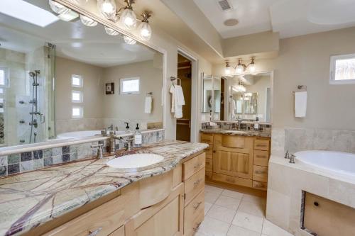 a bathroom with two sinks and two mirrors at Stunning Ocean View Home w Rooftop Terrace, Firepit, Fast Wifi, AC & Parking! in San Diego