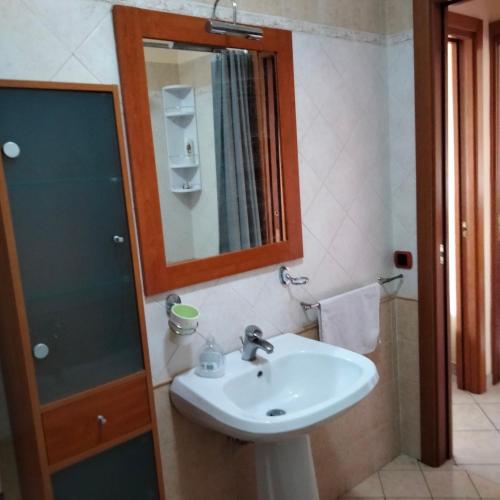 a bathroom with a sink and a mirror at Daniele's home close to Rome in Pomezia