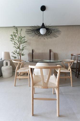 a dining room with a glass table and chairs at OCEAN VIEW DELUXE SUITE: PVT. BEACH & POOL in San Juan