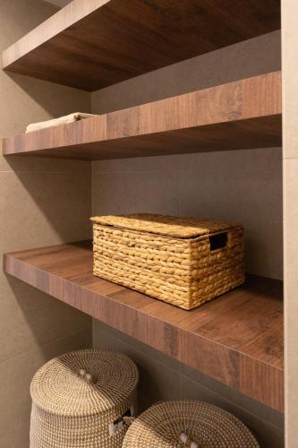 a basket sitting on a shelf with two stools at OCEAN VIEW DELUXE SUITE: PVT. BEACH & POOL in San Juan