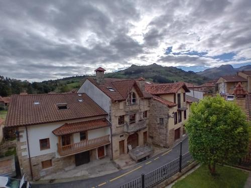 a group of buildings with mountains in the background at Posada Carpe Diem in Liérganes