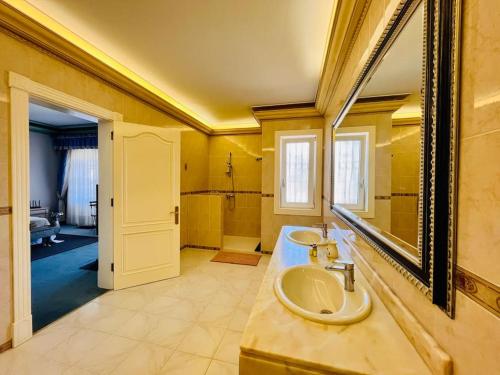a bathroom with a sink and a mirror at Kishni, peaceful and luxury suite villa in Arrecife
