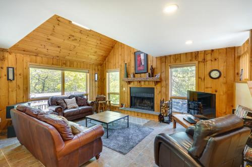 a living room with leather furniture and a fireplace at Fantastic 2 family vacation home with EV charger in Windham