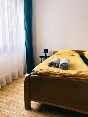 a bed with two pillows on it in a bedroom at City Center Apartments in Vilnius