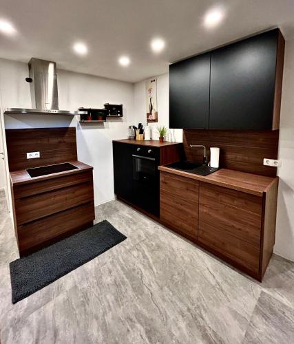 a large kitchen with wooden cabinets and a sink at My Appartements in Untertauern