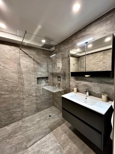 a bathroom with a sink and a shower at My Appartements in Untertauern