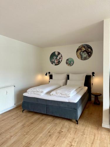 ein Schlafzimmer mit einem Bett und zwei Platten an der Wand in der Unterkunft Ferienwohnung Bad Sachsa Harz II in Bad Sachsa