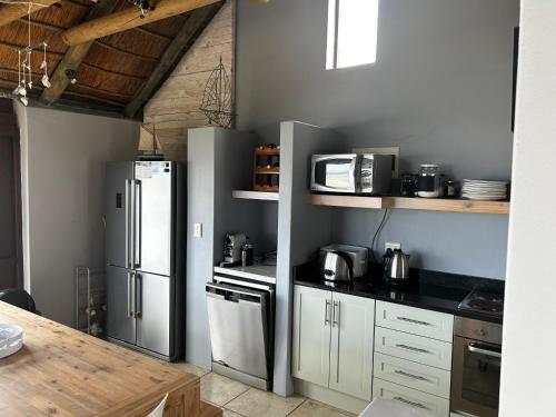 a kitchen with a refrigerator and a counter top at Breede View in Kontiki