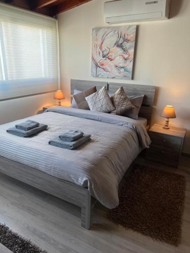 a bedroom with a large bed with two towels on it at Ellados 20 in Limassol