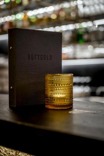a book sitting on a table next to a stack of gold coins at WITTMANNs in Neumarkt in der Oberpfalz