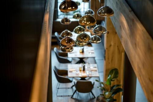 a row of tables in a restaurant with lights at WITTMANNs in Neumarkt in der Oberpfalz