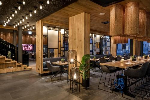 a restaurant with wooden walls and tables and chairs at WITTMANNs in Neumarkt in der Oberpfalz