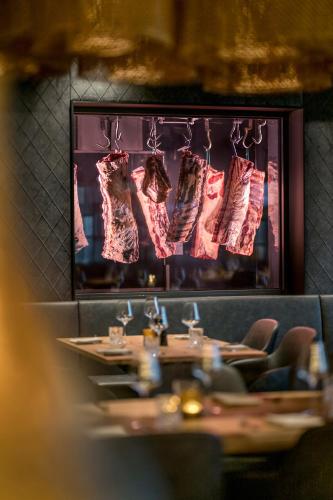 a dining room with a table with shoes hanging on a wall at WITTMANNs in Neumarkt in der Oberpfalz