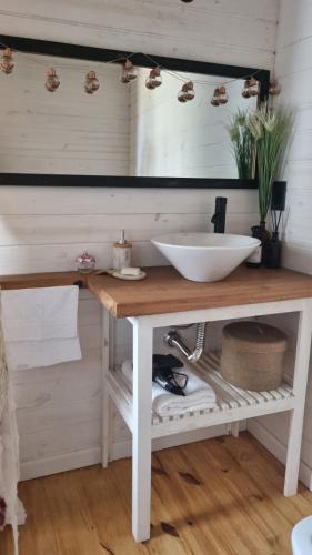 a bathroom with a white sink on a wooden counter at Juanillo's ll in Punta Del Diablo