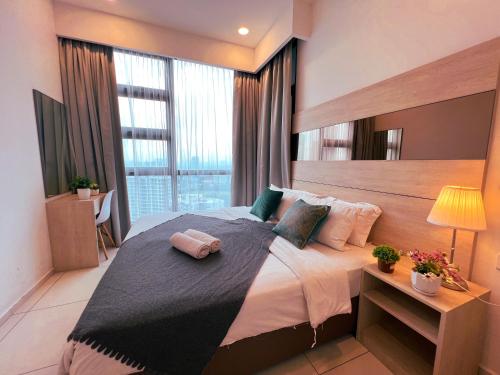 a bedroom with a large bed with a large window at Robertson by Shahjalal Suites in Kuala Lumpur