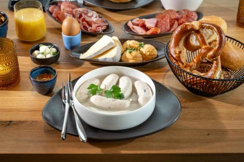 a table with a bowl of dumplings and other plates of food at WITTMANNs in Neumarkt in der Oberpfalz