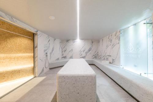 a room with a stone bench in front of a wall at KOPAONIK WOODSIDE 58,70 m2 FREE Parking in Kopaonik