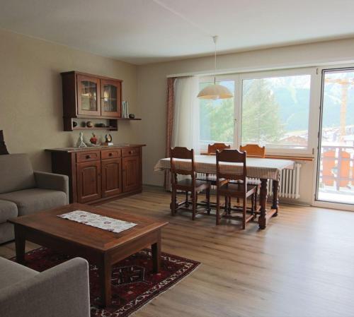 a living room with a table and a dining room at Appartement Mittaghorn Saas-Fee in Saas-Fee