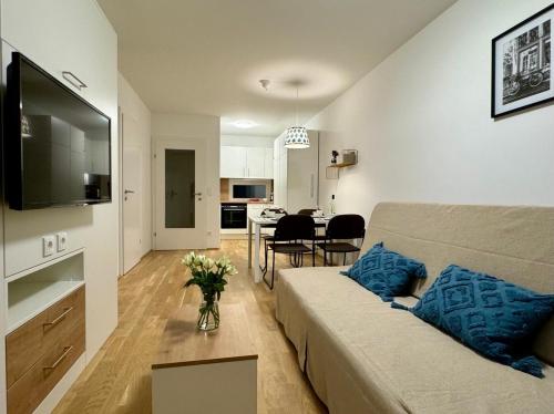 a living room with a couch and a dining room at Reload by BestChoice - Parking - Self Check-in in Graz