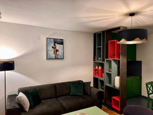 a living room with a couch and a book shelf at Pale Green in Pale