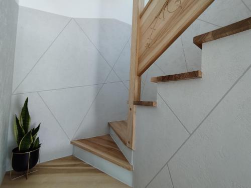 a staircase in a house with a potted plant at Jagodowe Domki in Ciche
