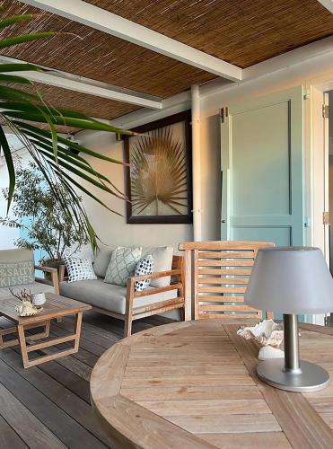 a living room with a couch and a table at On the Beach , in Saint Barth... Mellow Mood Villa in Saint Barthelemy