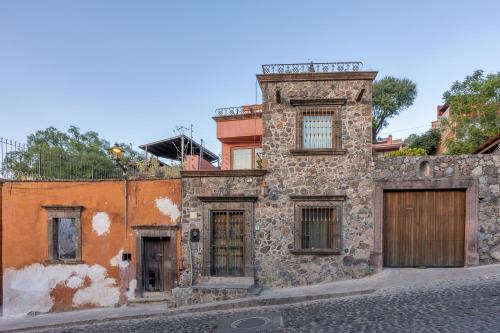 an old stone building on the side of a street at Casa de la Vista in San Miguel de Allende