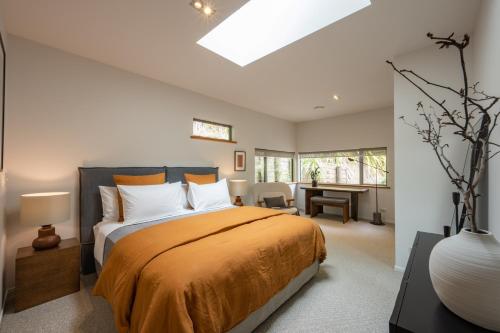 a bedroom with a bed and a desk in it at Okoro Villa in Nelson