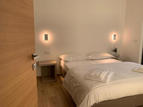 1 dormitorio pequeño con 2 camas y mesa en Bernina Suite 2 - vicino al Bernina Express en Tirano