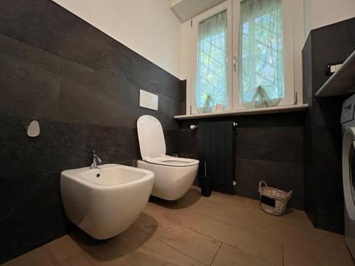 a bathroom with a toilet and a sink and a window at Acquedotti apartment with garden in Rome