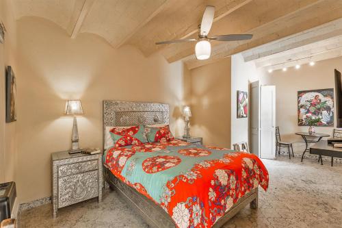 a bedroom with a bed and a ceiling fan at Casas Artistas in San Miguel de Allende