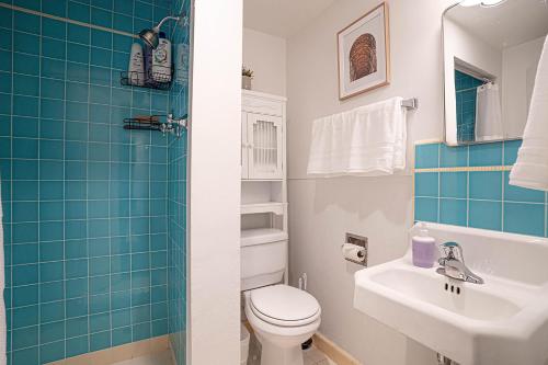 a bathroom with a toilet and a sink at Seaside Serenity 1-BR Apt with peek-a-boo sound views in Seattle